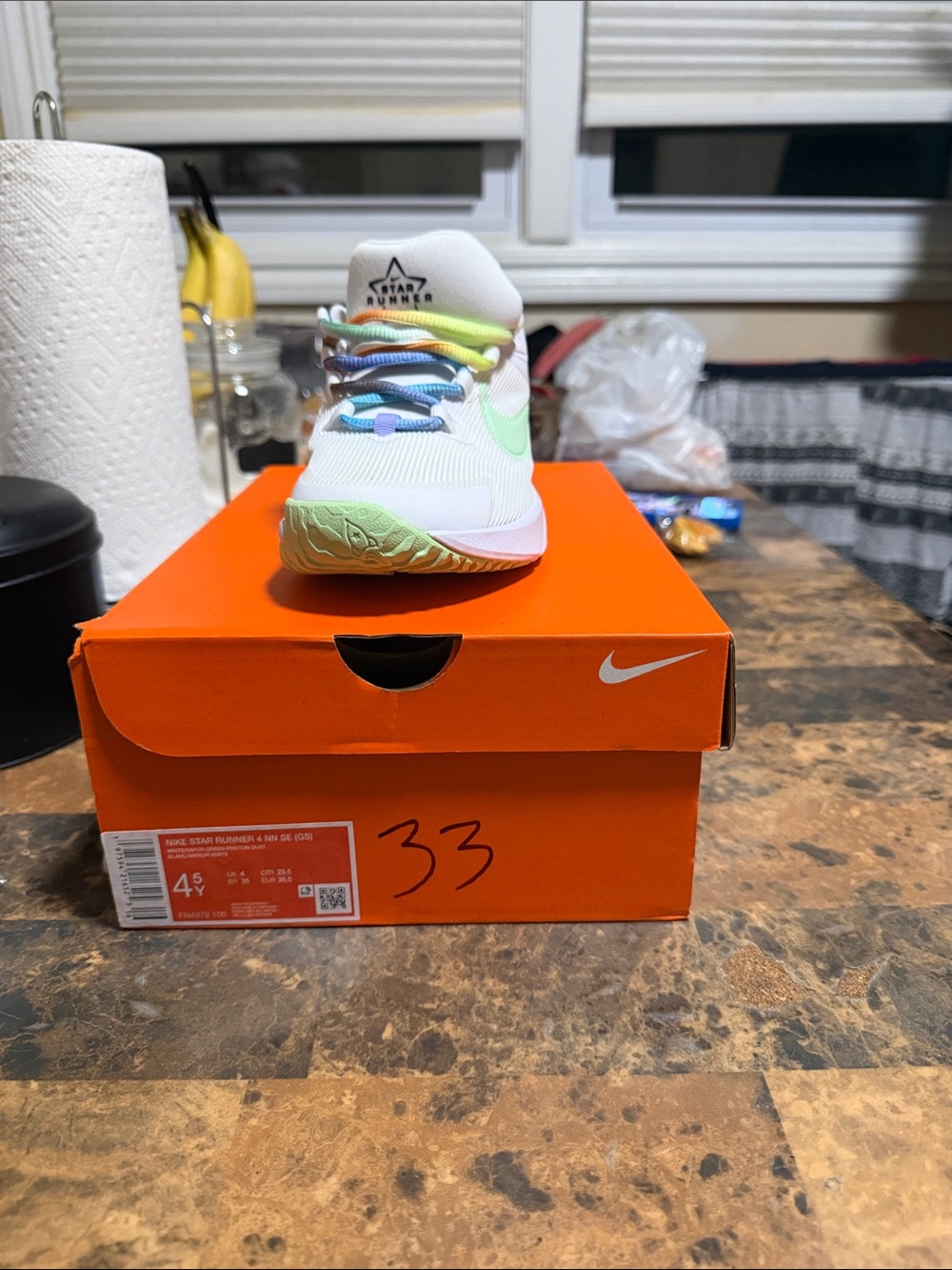 Nike Kids White Sneaker with Pastel Rainbow Accents